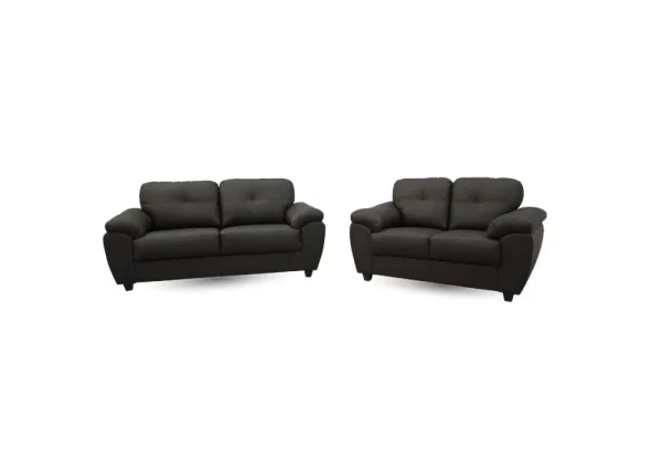 The modern Capri 3+2 seater sofa set in Soft Black faux leather, showing the elegant quilted back cushions and uniquely shaped padded armrests.