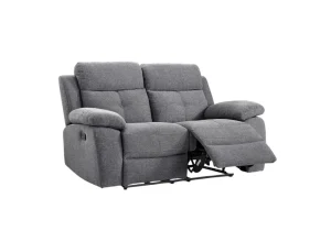 The Caro two-seater manual recliner loveseat in versatile grey fabric, showcasing its lever-activated reclining mechanism.